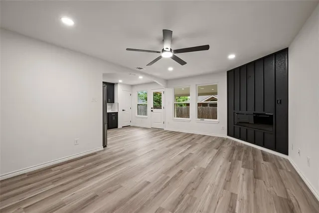 a view of a kitchen with a sink and a refrigerator