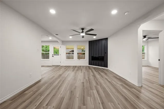 wooden floor in an empty room with a window