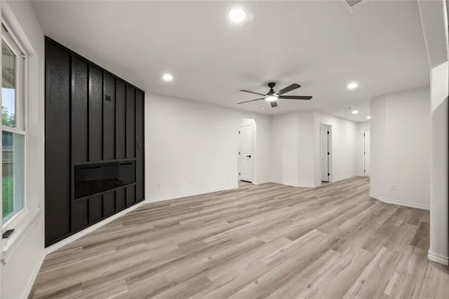 a view of empty room with wooden floor