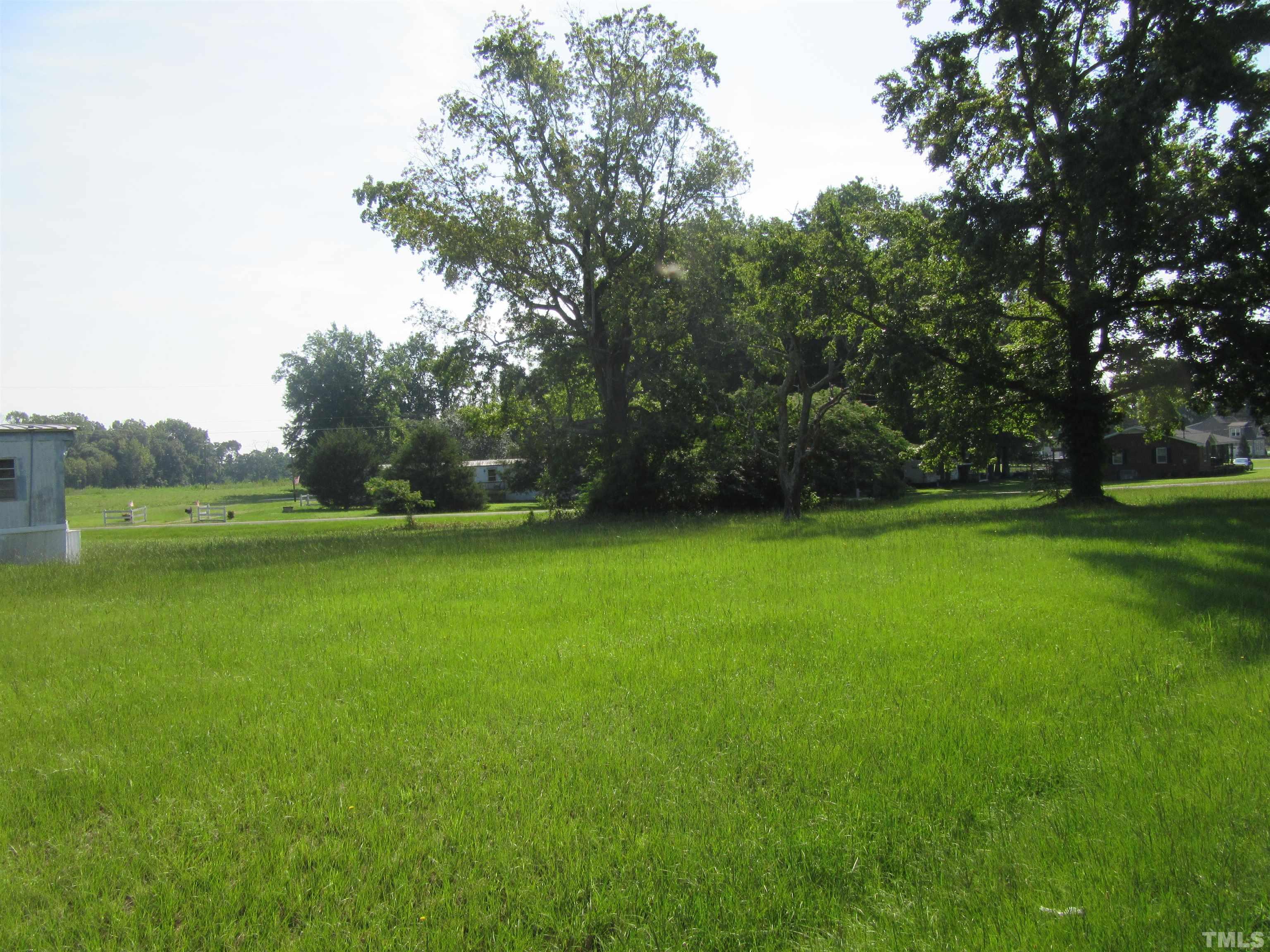 2476 Pilot-Riley Road, Unit LOT 6 Zebulon, NC 27597 - Photo 3 of 4 a view of a green field with wooden fence
