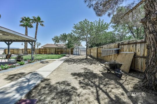 1260 Arroyo Street Ridgecrest, CA 93555 - Photo 41 of 44 a view of backyard with a table and chairs and potted plants