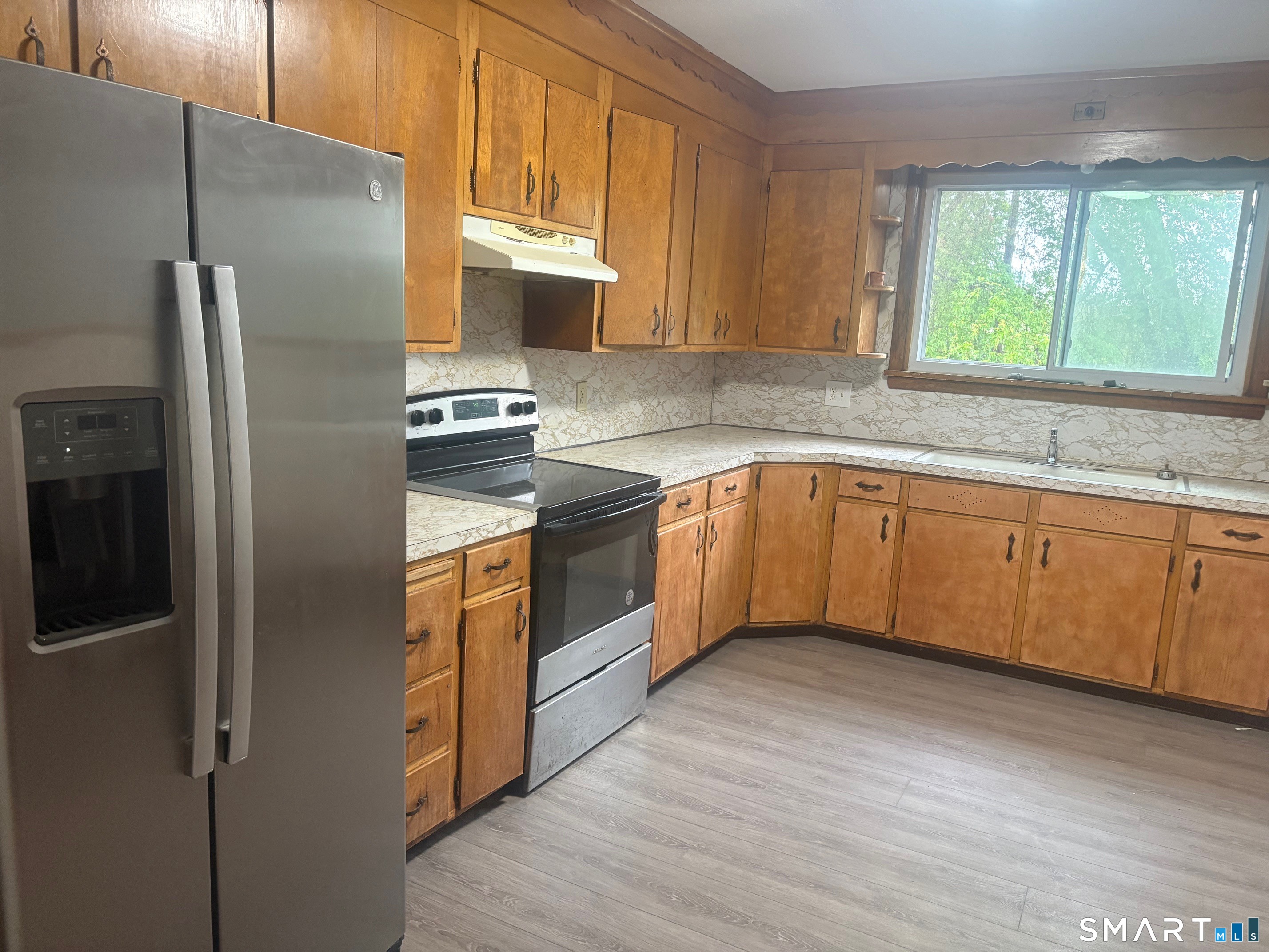580 High Street Middletown, CT 06457 - Photo 2 of 11 a kitchen with stainless steel appliances granite countertop a refrigerator a sink dishwasher a stove with wooden cabinets and floor