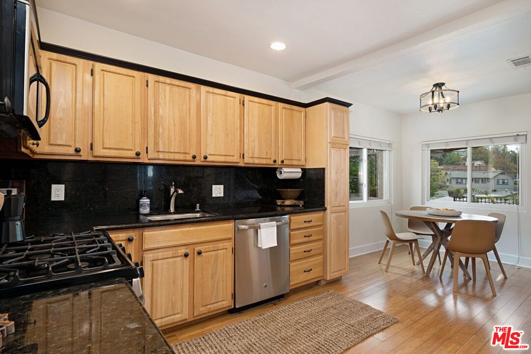 4905 Wiota Street Los Angeles, CA 90041 - Photo 14 of 38 a kitchen with stainless steel appliances granite countertop a stove a sink and a microwave