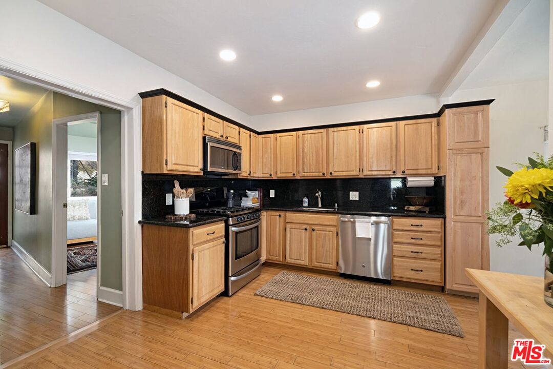 4905 Wiota Street Los Angeles, CA 90041 - Photo 15 of 38 a kitchen with stainless steel appliances granite countertop a stove a sink and a refrigerator