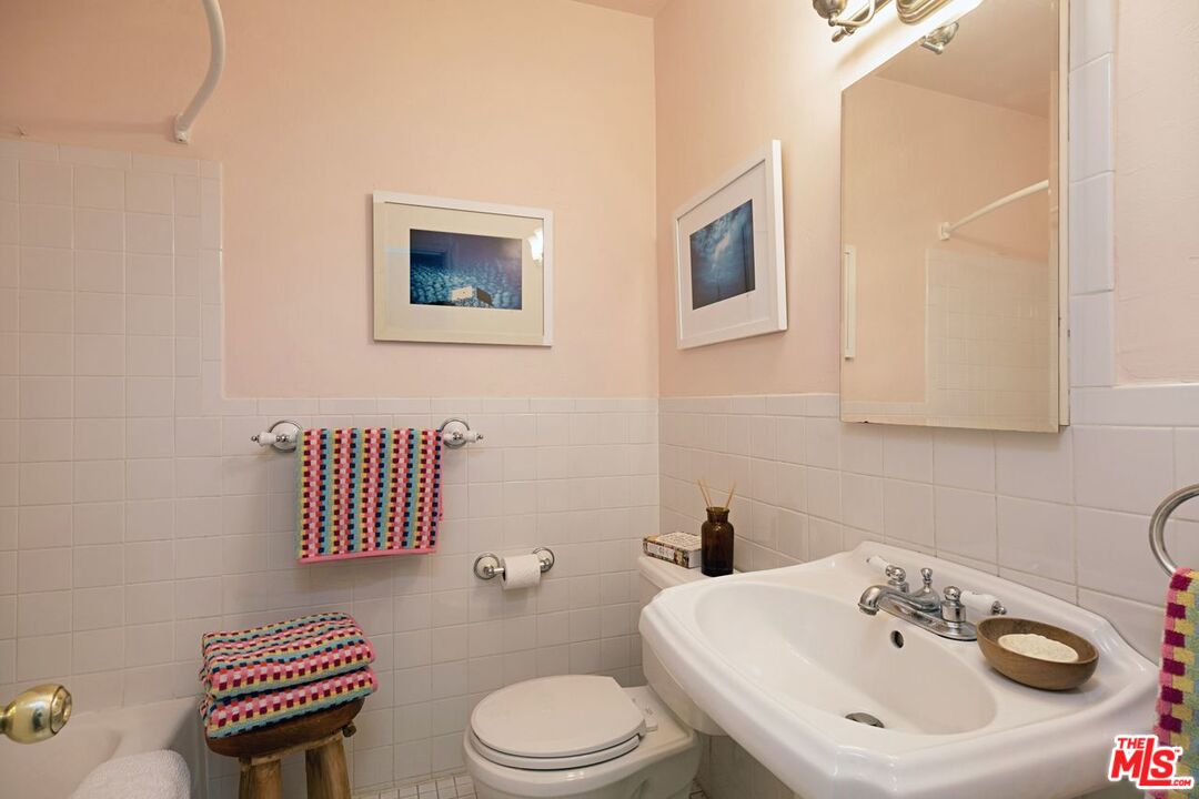 4905 Wiota Street Los Angeles, CA 90041 - Photo 19 of 38 a bathroom with a sink a toilet and mirror
