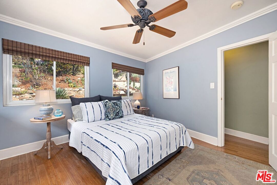 4905 Wiota Street Los Angeles, CA 90041 - Photo 23 of 38 a bedroom with a large bed chandelier and a window