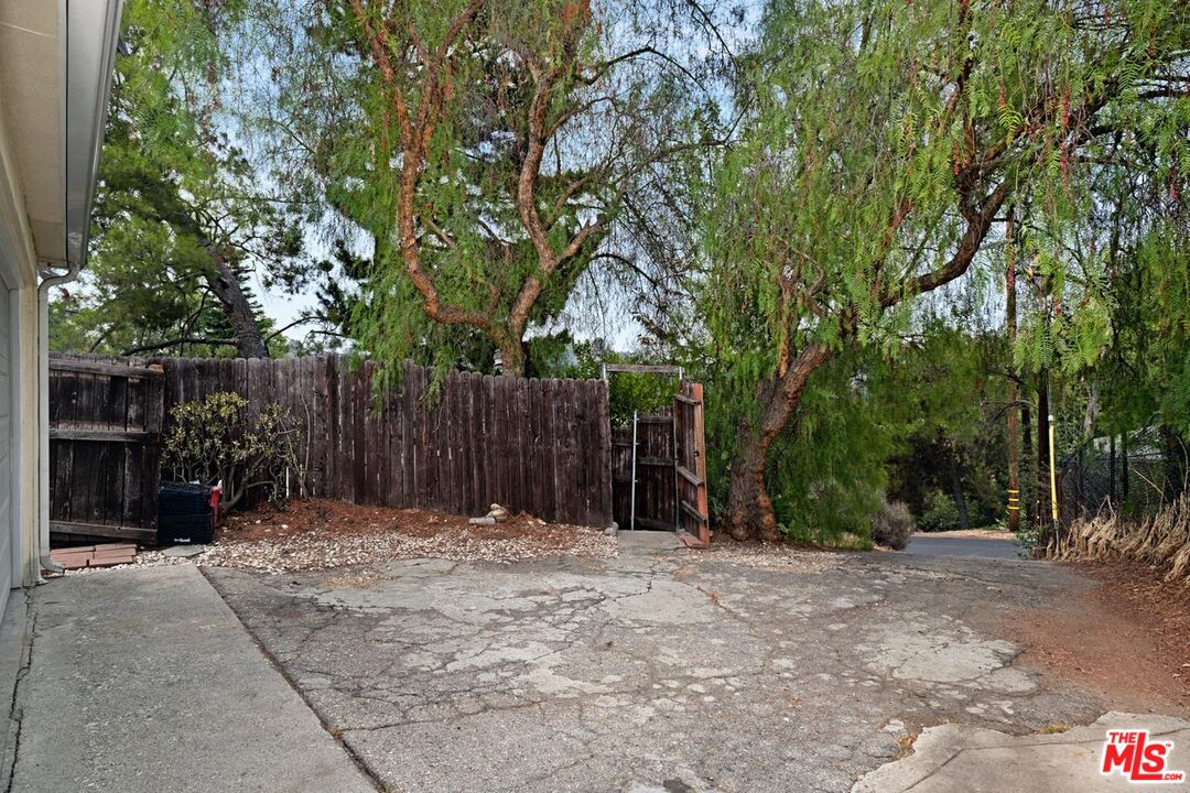 4905 Wiota Street Los Angeles, CA 90041 - Photo 36 of 38 a view of outdoor space with wooden fence and trees
