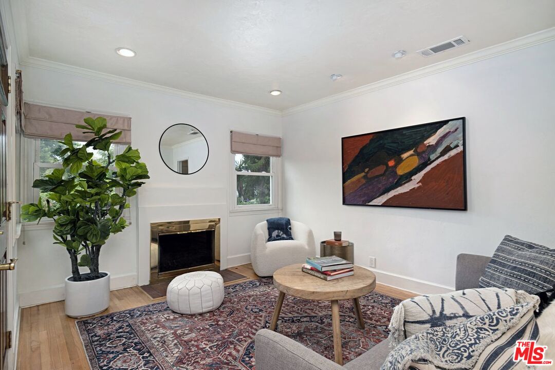 4905 Wiota Street Los Angeles, CA 90041 - Photo 8 of 38 a living room with furniture a fireplace and potted plant