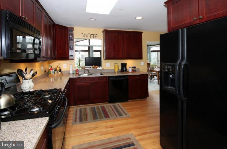 6108 Roxbury Avenue Springfield, VA 22152 - Photo 12 of 30 a kitchen with stainless steel appliances granite countertop a refrigerator stove and sink