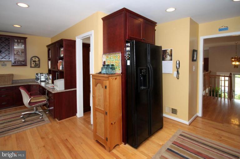 6108 Roxbury Avenue Springfield, VA 22152 - Photo 14 of 30 a view of a living room with furniture and a refrigerator