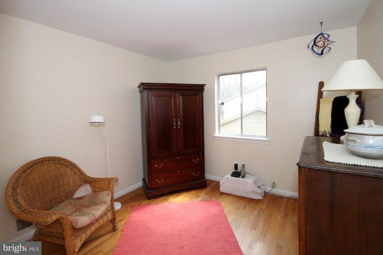 6108 Roxbury Avenue Springfield, VA 22152 - Photo 18 of 30 a bedroom with a bed and a dresser