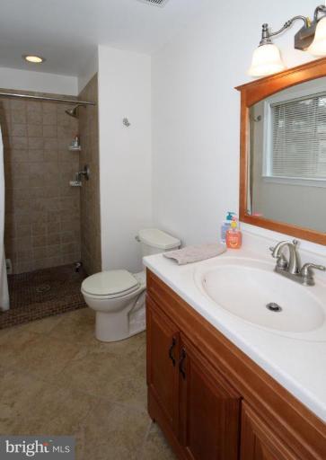 6108 Roxbury Avenue Springfield, VA 22152 - Photo 20 of 30 a bathroom with a sink a toilet and shower