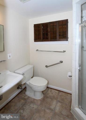 6108 Roxbury Avenue Springfield, VA 22152 - Photo 22 of 30 a bathroom with a toilet a sink and shower