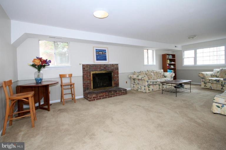 6108 Roxbury Avenue Springfield, VA 22152 - Photo 23 of 30 a living room with furniture and a fireplace