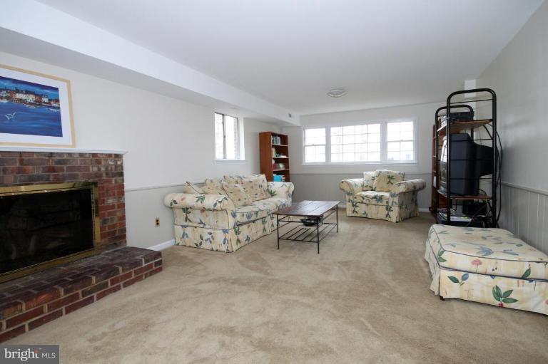 6108 Roxbury Avenue Springfield, VA 22152 - Photo 24 of 30 a living room with furniture and a fireplace