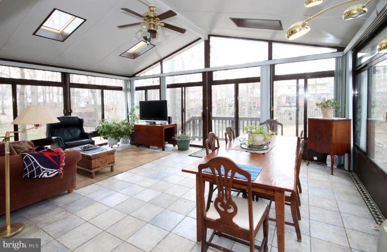 6108 Roxbury Avenue Springfield, VA 22152 - Photo 28 of 30 a living room with furniture and a floor to ceiling window