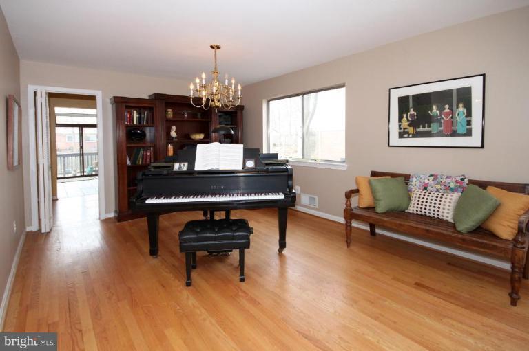 6108 Roxbury Avenue Springfield, VA 22152 - Photo 8 of 30 a living room with furniture and a chandelier