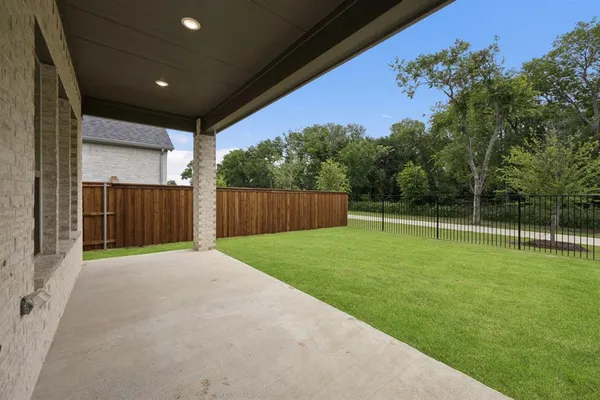 a view of a backyard with wooden fence