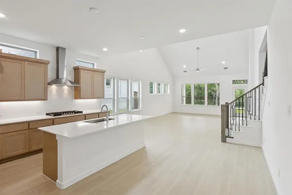 a large white kitchen with a large window