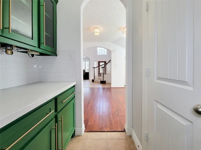 a view of kitchen with stainless steel appliances granite countertop a refrigerator and a sink