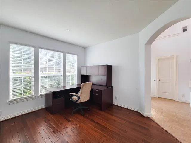 a view of a livingroom with lounge chair and a large window