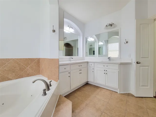 a view of a kitchen cabinets and a refrigerator