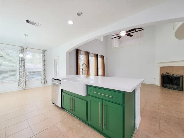 a view of kitchen with stainless steel appliances kitchen island sink and refrigerator