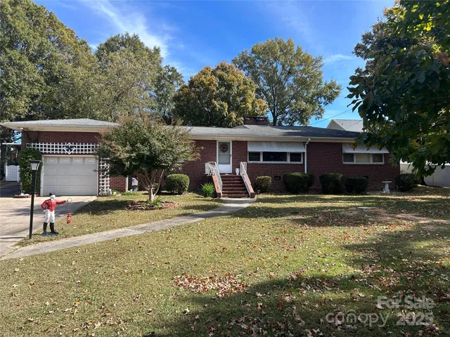 a view of a house with cars park