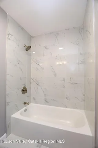 a bath tub sitting next to a white sink