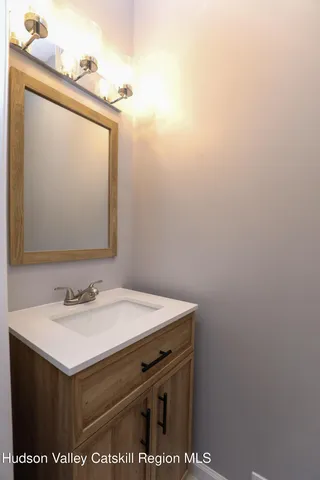 a bathroom with a sink vanity and a mirror