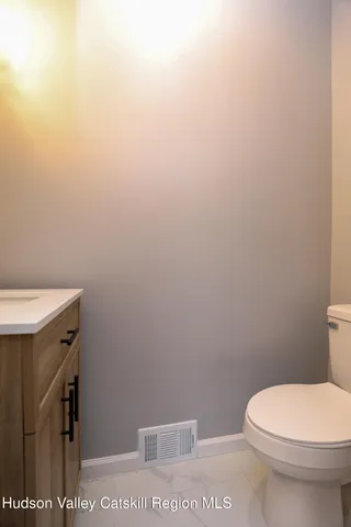 a white toilet sitting next to a shower