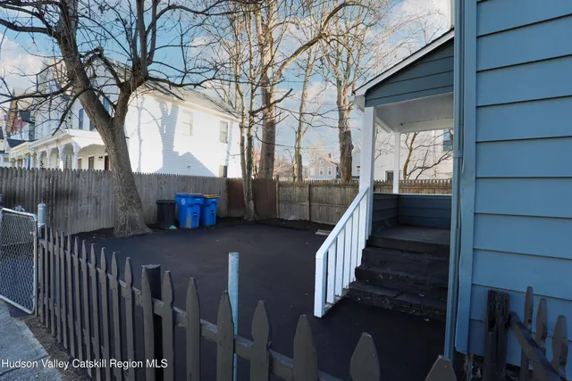 a view of a house with wooden fence