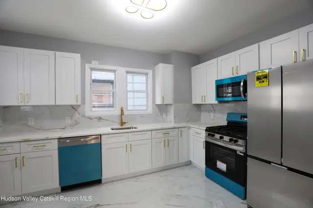 a kitchen with a sink appliances and cabinets