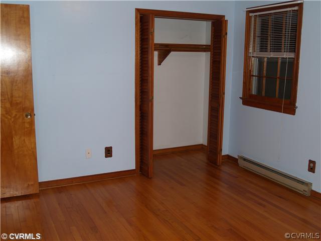 3319 Quaker Road Quinton, VA 23141 - Photo 7 of 11 a view of an empty room with wooden floor and a window