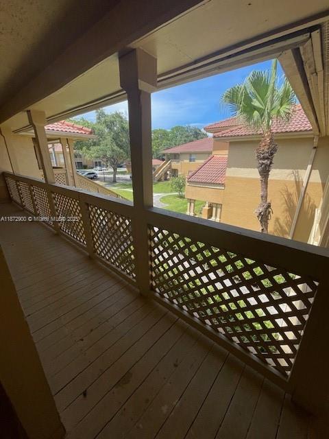 4751 Via Palm Lakes, Unit 419 West Palm Beach, FL 33417 - Photo 2 of 11 a view of a balcony with wooden floor