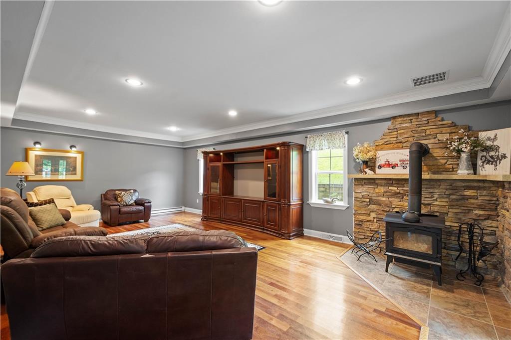 102 Klages Road West Alexander, PA 15376 - Photo 13 of 50 a living room with furniture a flat screen tv and a floor to ceiling window