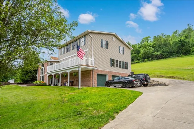 a front view of a house with a garden and yard