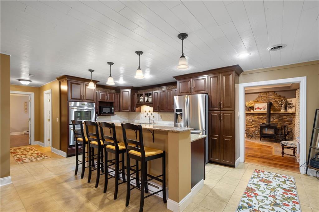 102 Klages Road West Alexander, PA 15376 - Photo 9 of 50 a kitchen with stainless steel appliances kitchen island granite countertop a refrigerator and microwave