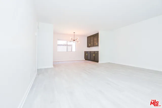a view of empty room with a window and fireplace
