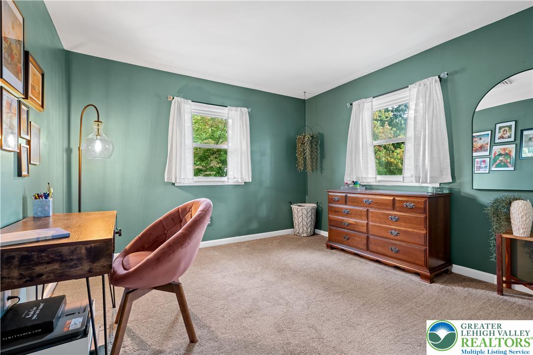 2569 Woods Edge Road Bath, PA 18014 - Photo 12 of 40 Double windows frame leafy outdoor views in a versatile room with soft carpeting.