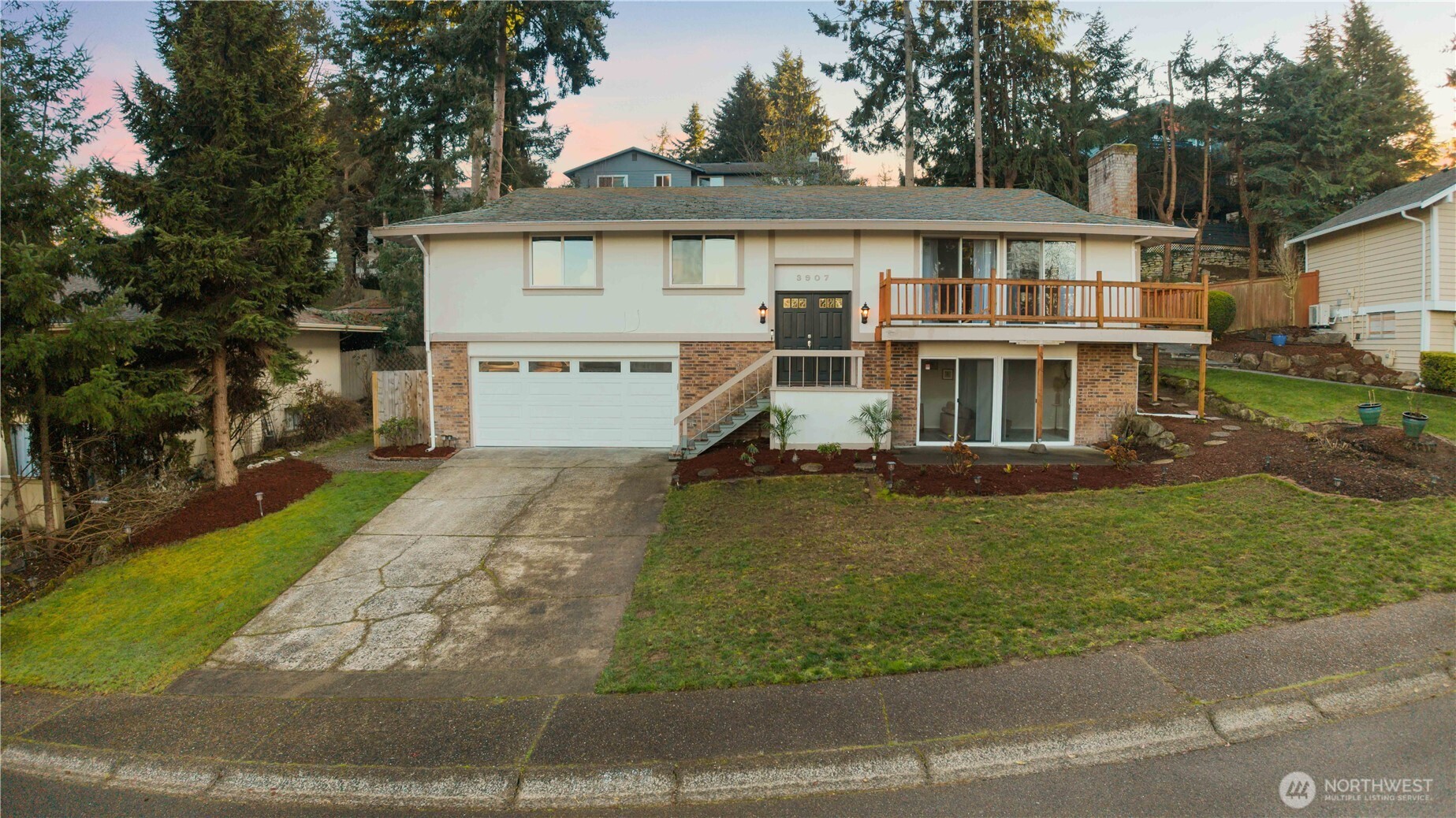 3907 Southwest 328th Street Federal Way, WA 98023 - Photo 3 of 40 a view of a white house next to a yard with big trees