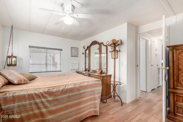 a bedroom with a bed dresser and a window