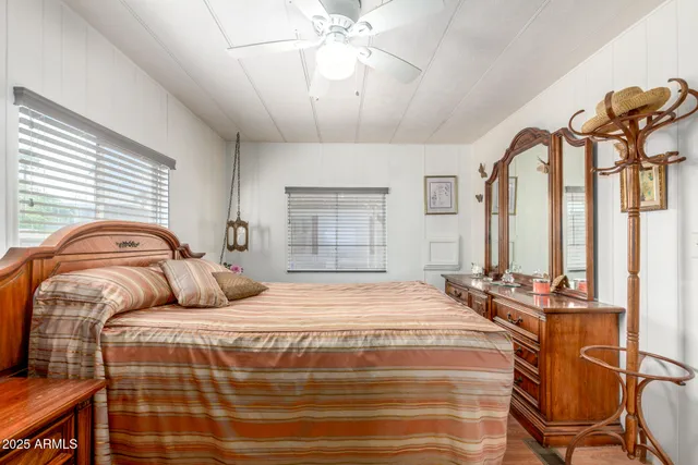 a bedroom with a bed and wooden floor