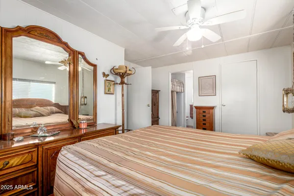 a bedroom with a large bed and a chandelier