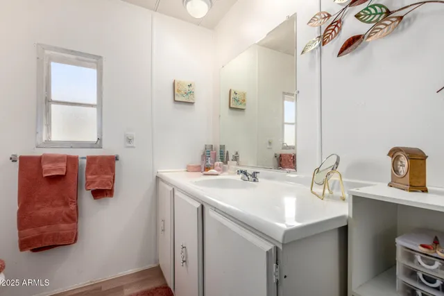 a utility room with a sink and a mirror