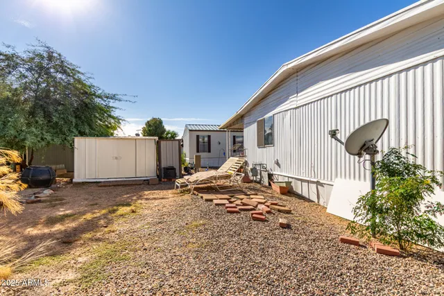 a backyard of a house with table and chairs