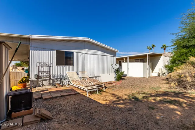 a backyard of a house with table and chairs