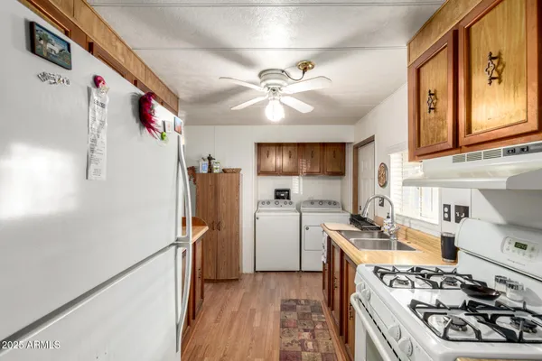 a kitchen with a refrigerator a stove top oven a sink and dishwasher