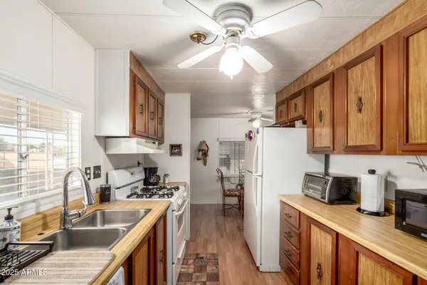 a kitchen with stainless steel appliances granite countertop a sink refrigerator stove and microwave