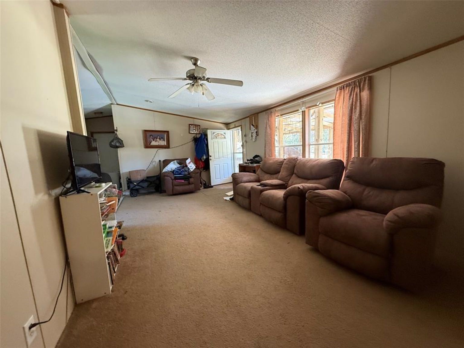 15432 O'Connor Drive Splendora, TX 77372 - Photo 12 of 12 a living room with furniture and a large window
